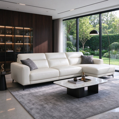 The sofa in a modern room with floor-to-ceiling garden windows, a wine cabinet, marble coffee table and grey rug
