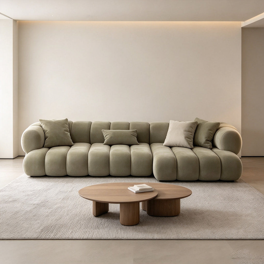 The modular sofa in a minimal room with a round oak coffee table and a neutral rug