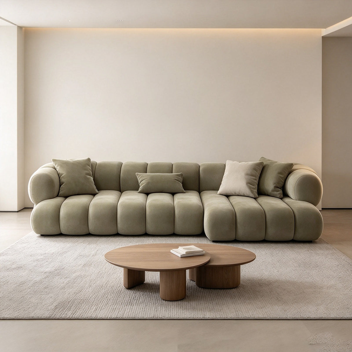 The modular sofa in a minimal room with a round oak coffee table and a neutral rug